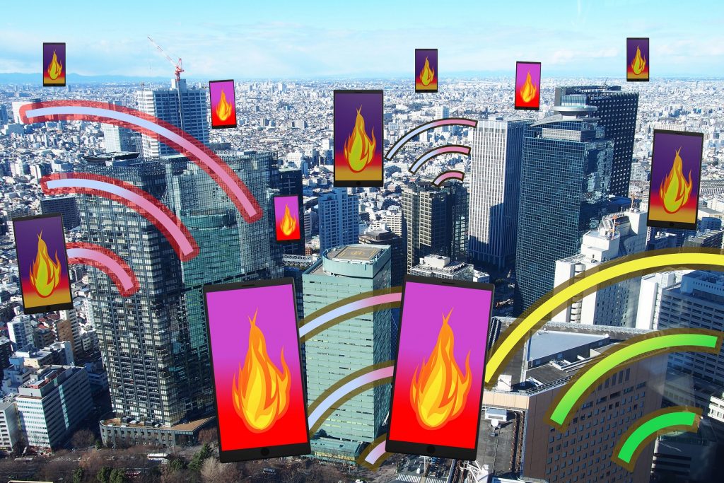 ビジネス街と火の画面のスマートフォン