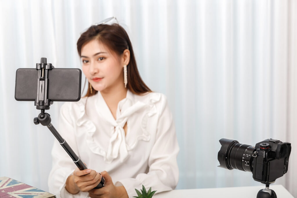 スマートフォンをカメラにして撮影している女性